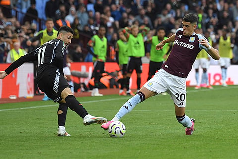 Premier League 2024-25: Aston Villa's Kosta Nedeljkovic, right, challenges for the ball with Arsenal's Gabriel Martinelli 